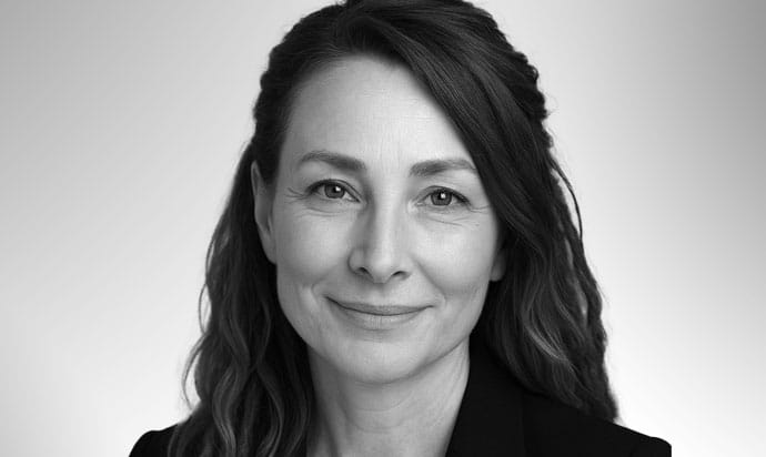 Therapy for personality disorders. Black and white headshot of woman smiling at the camera.