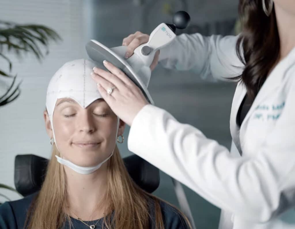 Female patient receiving TMS therapy at clinic
